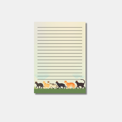 Whimsical Cats on the Grass Notepads